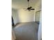 This bedroom features neutral carpet, mirrored closet doors, and a ceiling fan at 445 Fountainhead Cir # 264, Kissimmee, FL 34741