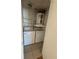 Inside laundry room with stacked washer and dryer, plus shelving at 445 Fountainhead Cir # 264, Kissimmee, FL 34741