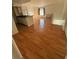 Bright living space with wood floors, natural light, and kitchen bar seating at 445 Fountainhead Cir # 264, Kissimmee, FL 34741