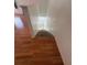 View of the stairs with wood flooring at the top and carpeted stairs leading to the lower level at 445 Fountainhead Cir # 264, Kissimmee, FL 34741