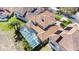 An aerial view of a private pool enclosed in screened enclosure and red tile roof on a sunny day at 478 Chelsea Ave, Davenport, FL 33837