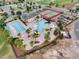 Aerial view highlighting a community pool, tennis courts, and manicured landscaping at 478 Chelsea Ave, Davenport, FL 33837