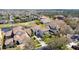 Aerial view of a neighborhood featuring tile roofs, mature trees, and well-manicured lawns on a sunny day at 478 Chelsea Ave, Davenport, FL 33837