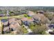 Aerial view of a neighborhood featuring tile roofs, mature trees, and well-manicured lawns on a sunny day at 478 Chelsea Ave, Davenport, FL 33837