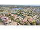 Aerial view of a neighborhood with tile roofs, and water features on a sunny day at 478 Chelsea Ave, Davenport, FL 33837