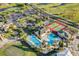 Aerial view of resort-style community amenities including pools, tennis courts, and lush landscaping at 478 Chelsea Ave, Davenport, FL 33837