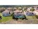 An aerial view of the house featuring a swimming pool in screened enclosure and a red tile roof at 478 Chelsea Ave, Davenport, FL 33837