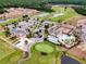 Aerial view of a community featuring a golf course, clubhouse, pools, and tennis courts at 478 Chelsea Ave, Davenport, FL 33837