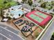 Aerial view showcasing community amenities, including a playground, pools, and tennis courts at 478 Chelsea Ave, Davenport, FL 33837