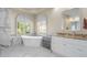 Elegant bathroom featuring a freestanding tub, marble accents, and abundant natural light at 478 Chelsea Ave, Davenport, FL 33837