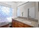 Bathroom featuring double sinks, granite counters, and a shower-tub combo with patterned curtain at 478 Chelsea Ave, Davenport, FL 33837