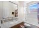 Well-lit bathroom featuring a granite countertop, vanity, shower and tub combination, and large mirror at 478 Chelsea Ave, Davenport, FL 33837