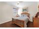 Comfortable bedroom with hardwood floors, neutral decor, and natural light at 478 Chelsea Ave, Davenport, FL 33837