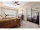 Bright bedroom with natural light, wood floor, and access to the outdoor living space at 478 Chelsea Ave, Davenport, FL 33837
