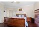 Comfortable bedroom featuring a wooden sleigh bed, bedside tables, and hardwood floors at 478 Chelsea Ave, Davenport, FL 33837