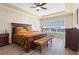 Spacious bedroom features a tray ceiling, wood floors, and large windows offering plenty of natural light at 478 Chelsea Ave, Davenport, FL 33837