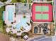 Aerial view showcasing community amenities including a pool, kiddie pool with slide, tennis court, and playground at 478 Chelsea Ave, Davenport, FL 33837