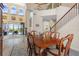 A view of the open dining room with a wood table, pool view, staircase, and access to the backyard at 478 Chelsea Ave, Davenport, FL 33837