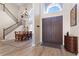 Elegant foyer with staircase, high ceilings, and wood flooring, leading into dining area at 478 Chelsea Ave, Davenport, FL 33837