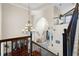 Grand foyer with a chandelier, arched doorways, and staircase with iron railings at 478 Chelsea Ave, Davenport, FL 33837