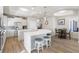 Kitchen featuring stainless steel appliances, white cabinets, an island with barstools, and an adjacent dining area at 478 Chelsea Ave, Davenport, FL 33837