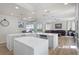 Modern kitchen with a large island, stainless steel appliances, and an open view to the pool and living area at 478 Chelsea Ave, Davenport, FL 33837