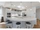 Bright kitchen with stainless steel appliances, white cabinets, bar seating, and pendant lighting at 478 Chelsea Ave, Davenport, FL 33837