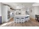 Kitchen with stainless steel appliances, white cabinets, an island with barstool seating, and wood flooring at 478 Chelsea Ave, Davenport, FL 33837