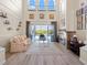 Light-filled living room with high ceilings, a stone fireplace, and access to the backyard pool at 478 Chelsea Ave, Davenport, FL 33837