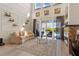 Spacious living room with a fireplace, tall ceilings, and a view of the outdoor pool area at 478 Chelsea Ave, Davenport, FL 33837