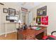 Home office with a desk, sports memorabilia, comfortable chair, and hardwood flooring at 478 Chelsea Ave, Davenport, FL 33837