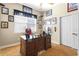 Inviting home office featuring a wooden desk, sports memorabilia, and ample natural light at 478 Chelsea Ave, Davenport, FL 33837