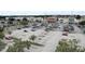 Aerial view of a shopping center with various retail stores and a parking lot filled with cars at 478 Chelsea Ave, Davenport, FL 33837