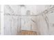 Luxurious marble tiled walk-in shower with designer tile accents and a mosaic tile floor at 478 Chelsea Ave, Davenport, FL 33837