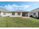 Large backyard with lush green grass, a screened lanai, and ample space for entertainment at 5151 Twin Lakes Blvd, St Cloud, FL 34772
