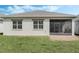 Large backyard with a screened lanai and lush green grass at 5151 Twin Lakes Blvd, St Cloud, FL 34772