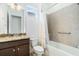 Well-lit bathroom with granite counters, tile flooring and shower, and updated fixtures at 5151 Twin Lakes Blvd, St Cloud, FL 34772