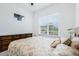 Bright bedroom with window and antique dresser, ceiling fan, and neutral colors at 5151 Twin Lakes Blvd, St Cloud, FL 34772