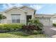 Charming single-Gathering home featuring a well-manicured lawn and a two-car garage on a sunny day at 5151 Twin Lakes Blvd, St Cloud, FL 34772