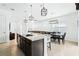 Spacious kitchen with a large granite island, stainless steel sink, and pendant lighting at 5151 Twin Lakes Blvd, St Cloud, FL 34772