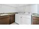 Functional laundry room with a sink, granite countertops, and a washer and dryer at 5151 Twin Lakes Blvd, St Cloud, FL 34772