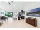 Expansive living room with open floor plan, adjacent dining area, and seamless access to the outdoor patio at 5151 Twin Lakes Blvd, St Cloud, FL 34772