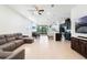 Inviting living space with an open floor plan, tile flooring, comfortable seating, and a modern kitchen at 5151 Twin Lakes Blvd, St Cloud, FL 34772
