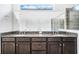 Bright main bathroom featuring double sinks, granite counters, and an elegant glass shower at 5151 Twin Lakes Blvd, St Cloud, FL 34772