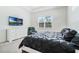 Bright main bedroom featuring a TV, large window, dresser, and an accent chair at 5151 Twin Lakes Blvd, St Cloud, FL 34772