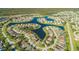 Panoramic aerial view of a lakeside community, showcasing homes and a network of winding waterways at 5516 Willow Bend Trl, Kissimmee, FL 34758