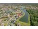 Aerial view of a neighborhood with lakes, houses, and lush landscaping at 5516 Willow Bend Trl, Kissimmee, FL 34758