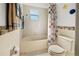 Bathroom featuring a bathtub, a shower curtain, and mosaic tile accents above the baseboard at 5516 Willow Bend Trl, Kissimmee, FL 34758