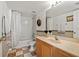 Well-lit bathroom featuring a tub with shower, toilet, and vanity with large mirror at 5516 Willow Bend Trl, Kissimmee, FL 34758