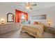 Bright bedroom featuring a ceiling fan, large window with drapes, and neutral-toned furniture at 5516 Willow Bend Trl, Kissimmee, FL 34758